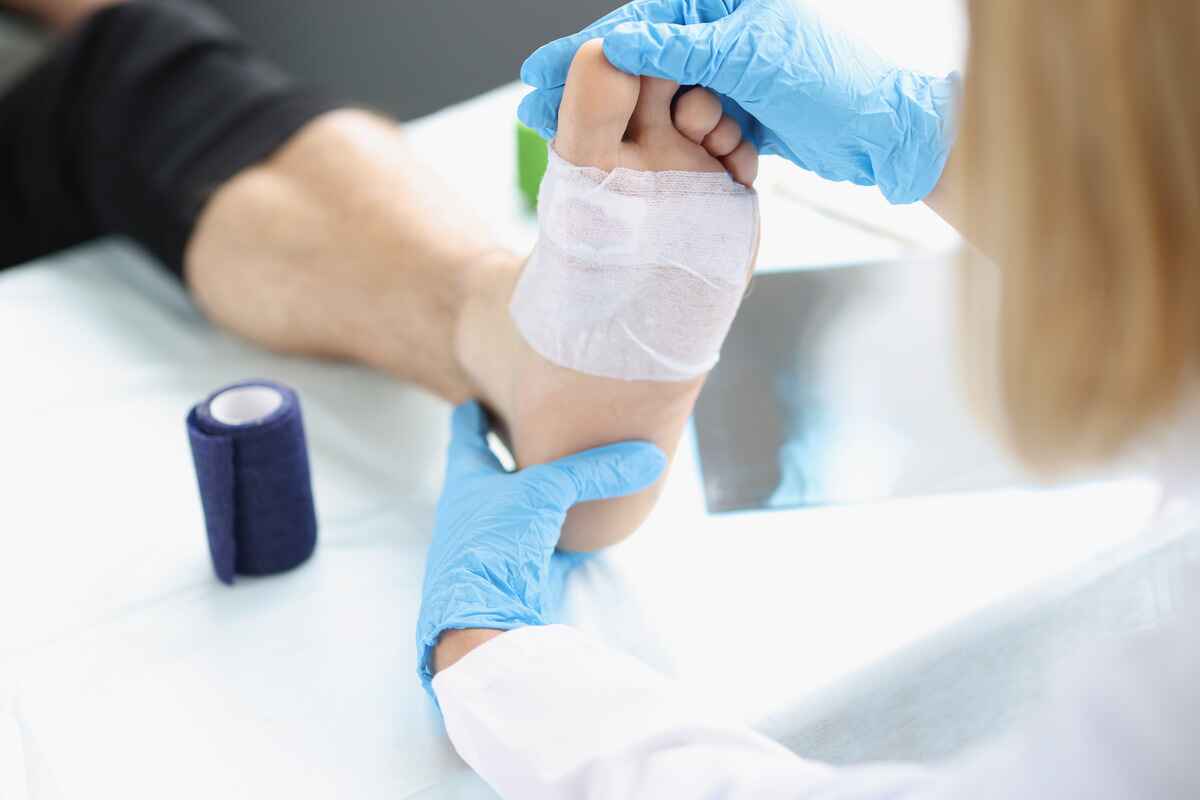 Doctor treats patient with foot wound